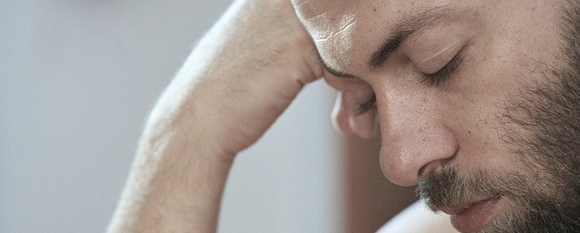 Tired man with hand to head