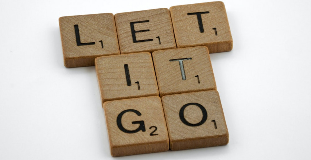 Scrabble tiles spelling "Let It Go"