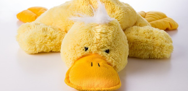 Yellow toy platypus laying prone